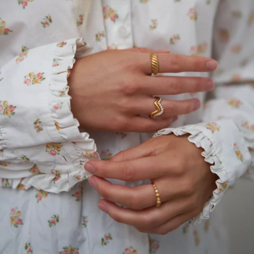 Close up of some of byBiehls rings on a grils hands